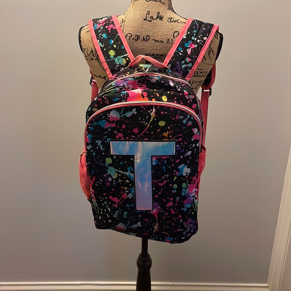 Justice book-bag. T on one side and nothing on the other. Flip book-bag.